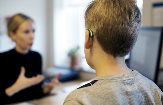 Barn med høreapparat på klinik